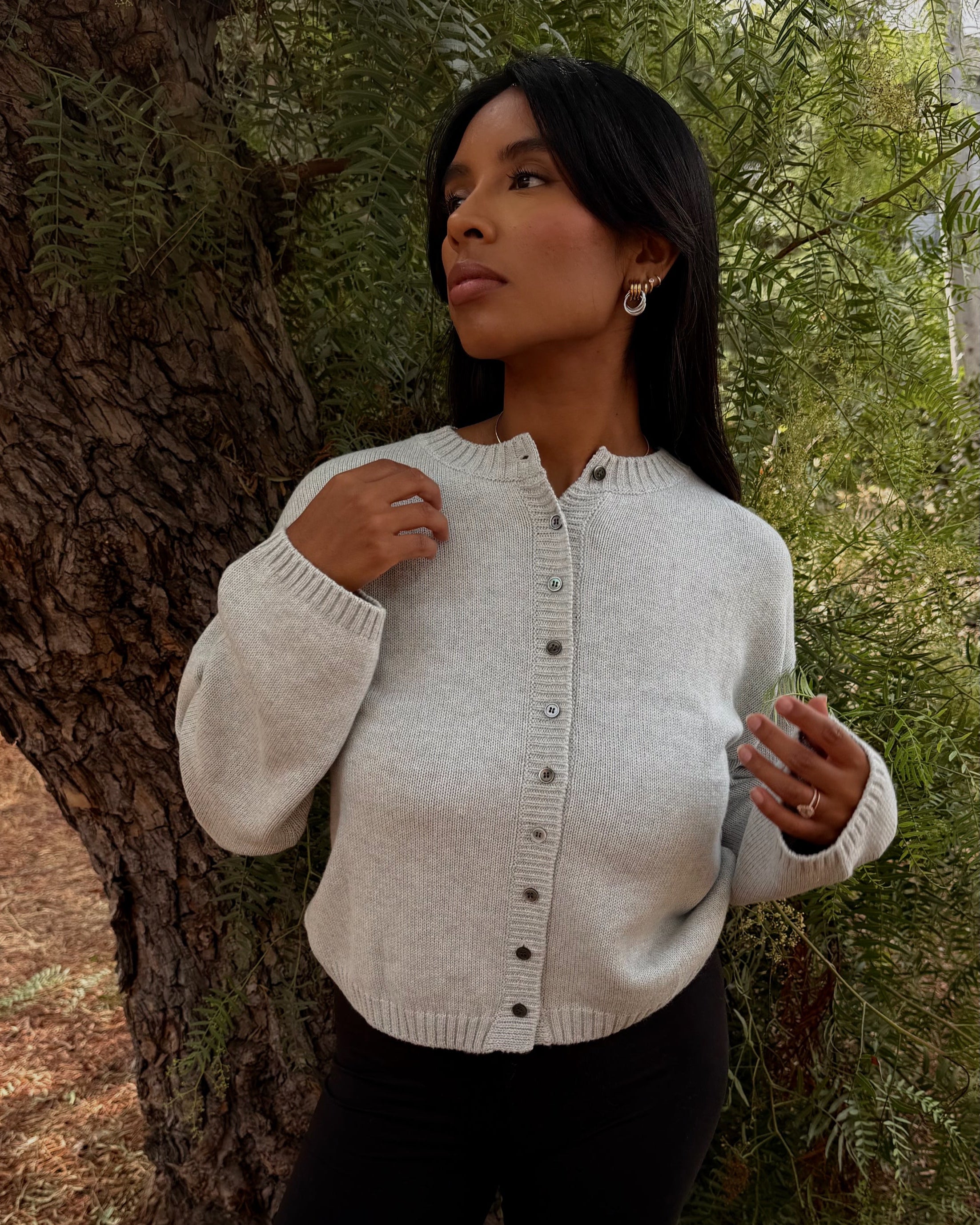 Woman wearing an ash cardigan in a forest setting